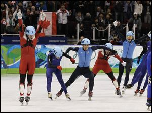 Canada's Francois-Louis Tremblay, left, reacts after winning the 5000-meter relay ahead of South Korea's Kwak Yoon-gy, second from left, and the United States' Apolo Anton Ohno, center.