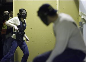 Reporter Bridget Tharp encounters an armed man played by Officer Patrick Bergman in Decision Alley.