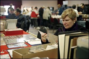 Slug: CTY stamp01p Date:  02282010     Andy Morrison       Location: Toledo  Caption: Joanne Haag, Cincinnati, pours through a stack of postcards at the 86th Annual Toledo Stamp Expo '10, at Holland Gardens, Sunday, 02282010. Summary.