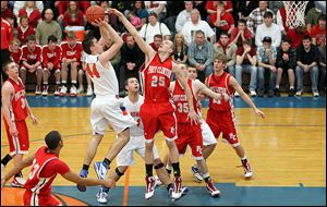 Port Clinton's Ryan HIcks tries to block a shot by of Edison's Ryan Reber. Hicks, a 6-foot-6 senior,
averages 16.4 points and 10.3 rebounds and was named Sandusky Bay Conference's outstanding performer. 