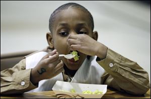 Quincy Harris is a bit hesitant as he samples some green eggs and ham during a celebration of the late Dr. Seuss' birthday at Riverside Elementary. Fifth graders at the school yesterday also made ‘Cat in the Hat'-style headgear and read stories by Theodor Seuss Geisel, who was born March 2, 1904, and wrote and illustrated 44 children's books before his death in 1991.