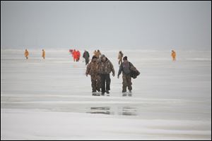 CTY icerescue07p   02/07/2009     The Blade/Lisa Dutton        Ice fishermen begin to make they way back to shore after being strand out in Lake Erie. Over 100 fishermen were  trapped on Lake Erie because of cracks that developed in the ice when they were on the lake. When ice shifted in the windy weather, it caused  the fishermen to be stranded  about 1,000 yards off the shore. Emergency personell from Jerusalem Township and Lucas County were on the scene at Crane Creek State Park in Ottawa County, the fishermen were stranded  off Magee Marsh in Lucas County.