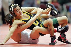 Clay's Nick Garcia, top, struggles against Cleveland St. Ignatius' George DiCamillo at the state tournament in Columbus.