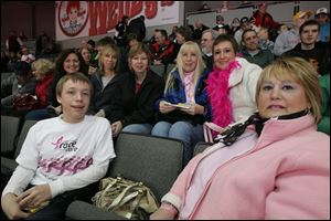 Cindy Rizzo, back row at right, attended the 'Pink on the Rink' Toledo Walleye game with her family, including son Zack Rizzo, 16, front row at left, and her sister, Chris Krzyminski, front right. Back row, from left, are Mrs. Rizzo's friends Colleen Wittenmyer, Renee Kane, Michelle Roberts, and Marianne Melton.