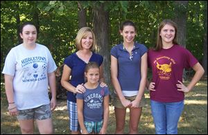 Cancer survivor Karla Batt, second from left, with goddaughters Jordan Soden, Hanna Schaffer, Madison Batt and Mikayla Batt at her 'No Chemo Party.'