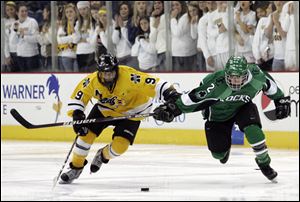 Northview's Nolan Culver gets to the puck before Evan Bowdy. Culver scored two goals in the Wildcats' semifinal victory.