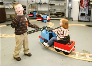 CTY trains15p  Older brother Carson Koomen, 5, tells their dad that Carly, 2, his sister, is ready to get off 