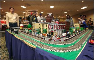 CTY trains15p   Jim Garrett, of Redford, Michigan, left, a member of the Michigan Lego Train Club, near the all-Lego train. There are approximately 100,000 Legos in the trains, buildings, cars, etc that comprise the entire scene. The 11th 