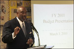 School board member Larry Sykes addresses the hearing at Waite High School that he organized. It drew about 75 attendees.  