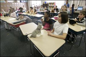 Tatelynn Linares, foreground, and the others in the Holland Elementary class with their stuffed animals track the Iditarod.