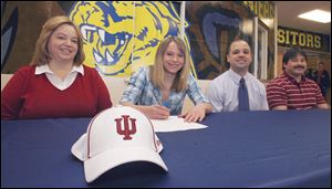 At a signing ceremony at Whitmer, Sammi Gwin is flanked at left by her mother, Shari Gwin; her track coach, Jeremy Elliott, and at far right her father, Steve.