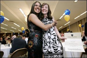 the blade/dave zapotosky
Sapna Shah of Detroit, left, embraces Katie Cabanski of Toledo after they learn they are both heading to Chicago for their residencies. Match Day was held yesterday at the Stranahan Theater.
