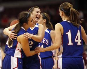 Liberty-Benton's Caite Craft, left, celebrates the Eagles state championship win with teammates Catelen Ramsey, (2) and Amber Petersen (14). It was the first girls state title and first perfect year.
<br>
<img src=http://www.toledoblade.com/graphics/icons/photo.gif> <font color=red><b>PHOTO GALLERY</b></font>: <a href=