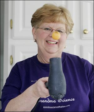 Mrs. Shock uses a hair dryer to show how an air current can keep a ball afloat.