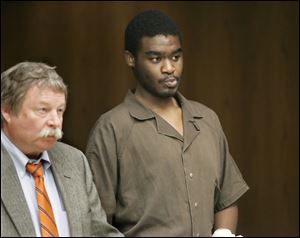 De'Lexis Andre Maloy, in court with public defender James MacHarg, is being held on $1.1 million bond.