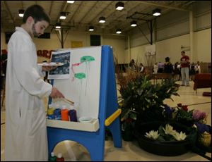 In a beard of mascara, St. Joan of Arc student Marc Monnette of Holland portrays Claude Monet painting a scene as part of the school's annual 'wax museum' depicting famous people.