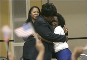 WilliAnn Moore, president of the Toledo NAACP, hugs Tayeana Willis, right, after Miss Willis sang ‘The Greatest Love of All.' In addition to the performances, students presented their creative writing projects, which dealt with the U.S. census.
