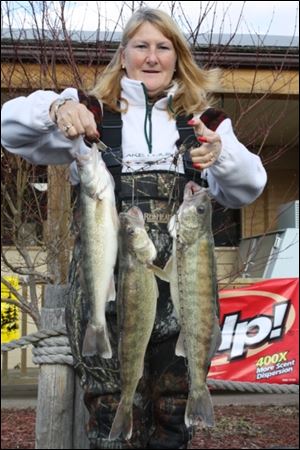 Cornelia Wagner of Whitehouse holds up a stringer of three walleye she caught off Maumee River.