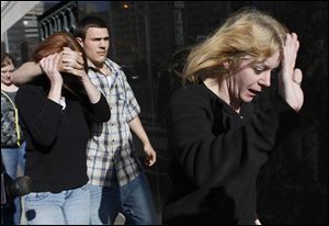 Donna Stone, right, David Brian Stone's ex-wife, leaves the Federal Courthouse in Detroit. Yesterday's detention hearing included Mr. Stone and seven others.