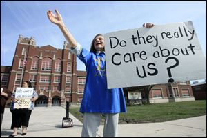 Sue Terrill, a 1966 Libbey High graduate, rallies with other alumni and parents outside the South Toledo school yesterday. The school, which has some 600 students, is targeted for closing under Board of Education plans to balance a budget that currently is in deficit by $30 million.