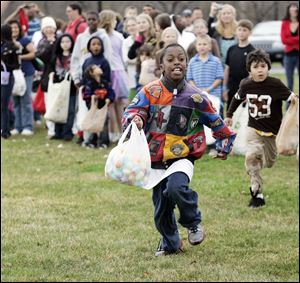 A rush for eggs — thousands of the colored plastic kind filled with candy, money, or trinkets  — results in full bags for children at the Church on Strayer in Monclova Township.