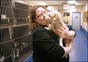 Dog Warden Julie Lyle holds ‘Pinky', a female terrier mix that is up for adoption again after the person who originally adopted her recently died.