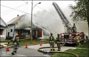 Toledo firefighters battle a blaze described as suspicious at two vacant South Toledo structures. Both houses were unoccupied, assistant Toledo Fire Chief Luis Santiago said. The fire began at 355 Havre St. near Western Avenue shortly before 4 p.m. yesterday and quickly spread to the upper floor of 353 Havre.