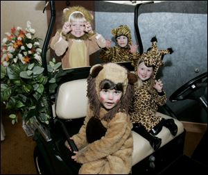 Hailey Curtis, front, and, behind her, from left, Charlie Krzyminski, Grant Dzierwa, and Brianna Rotterdam at the Toledo Children's Hospital 'Going Wild for Kids!' event at the Hilton Garden Inn.
<BR>
<img src=http://www.toledoblade.com/graphics/icons/photo.gif> <font color=red><b>PHOTO GALLERY</b></font>: <a href=