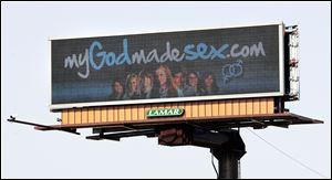 An electronic billboard on Monroe Street near Sylvania Avenue flashes a message about CedarCreek Church's sex-ed seminars.