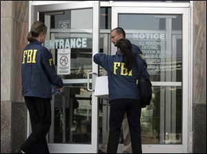 On July 28, 2008 , FBI agents enter a city-county building in downtown Cleveland during an investigation of public corruption. The same day, agents raided the homes of Cuyahoga County Commissioner
Jimmy Dimora, at far left, and county Auditor Frank Russo, near left. Neither has been charged and both deny wrongdoing, but voters nevertheless opted to change their government.
