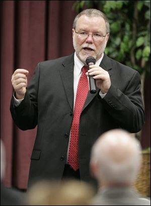 Jim Richardson answers questions during a public forum Monday at Owens. Mr. Richardson said that he does indeed wish to move to the Toledo area, after he was quoted in his hometown newspaper as saying he wants to remain at his present job in Washington.