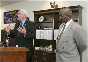 Public Utilities Director Tom Crothers, left, and Mayor Mike Bell discuss the city's new approach toward delinquent utility bills.