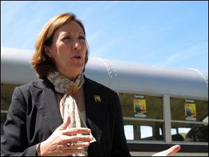 ** FOR USE AS DESIRED WITH ELECTION STORIES ** In this April 27, 2010 photo, U.S. Senate candidate Jennifer Brunner, D-Ohio,  speaks with supporters in Toledo, Ohio. Brunner is traveling the state in an old school bus bought on eBay, seen in background.  Brunner and Lt. Gov. Lee Fisher are the two leading Democrats in Ohio's Senate race. (AP Photo/John Seewer)