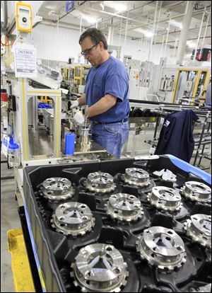 Toledo Powertrain employee Mike Saylor runs tests to prepare for production of a new front-wheel-drive transmission.