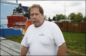 Dale Hilkens, who tends bar at Rivalry's in Bedford Township, says customers who
want to smoke have been going outside and the new law ‘has not been a problem.'