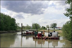 A dredge works the Ottawa River near Stickney Avenue.