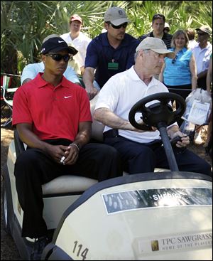 Tiger Woods said he didn't know what caused the neck pain but left on a cart after his second shot on No. 7 at The Players Championship.