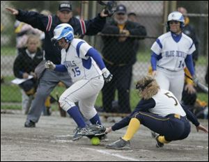 Springfield's Jesse Zappone scores as Notre Dame catcher Jenna Inman tries to pick up the ball in yesterday's
Division I sectional final. The Blue Devils improved to 17-6.