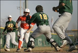 David Vandercook, above, charges toward home plate in a game against Clay. Brother Todd, below, scores for Sylvania in the same game.