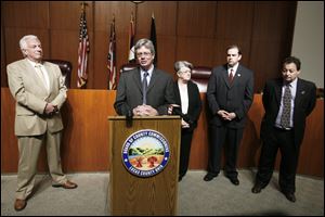 Lucas County Commissioner Pete Gerken, at podium, presents his government reform plan with, from left, county Democratic Party Chairman Ron Rothenbuhler, Recorder Jeanine Perry, Treasurer Wade Kapszukiewicz, and Clerk of Courts Bernie Quilter. 