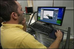 Zack Ward photographs the tortoises in the TechTol studio. The firm received a $50,000 development grant two years ago. 