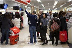 A crowded New York department store is a sign of consumer confidence, but recent slowing of spending has spurred worries among economists that recovery could be stymied. 