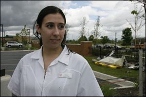 Melissa Prybor, from Toledo, a pharmacy intern at Walgreen's, was to work her first day Sunday at the Dundee store. Some of the damage from the store is at right.
