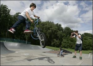 Zak Karnowski, 16, performs a slick trick while his friend James Dickens, 15, captures it on video at the skate park in Highland Park in South Toledo. 
<br>
<img src=http://www.toledoblade.com/assets/gif/weblink_icon.gif><b><font color=red> LINK:</b></font>
<a href=