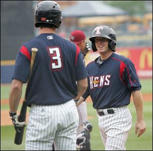 Mud Hen infielder Will Rhymes, right, being congratulated by teammate Brent Dlugach, started strong, but stumbled on road.