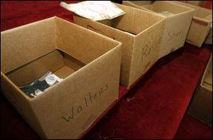 A station was set up inside the unscathed St. Peter's United Church of Christ in Millbury, where belongings of the victims were being sorted out in boxes marked with their families' names. 