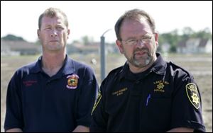Lake Township Fire Chief Todd Walters, left, and Police Chief Mark Hummer update residents. Both departments are operating, and both chiefs praised help they received from other agencies. 