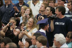 Families and friends of the Class of 2010 cheer and record the festivities.