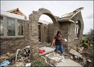 Jami Wyatt leaves what remains of her home on Reiman Road in Ottawa County's Allen Township. 