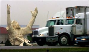This file photo shows traffic on I-75 just north of Monroe, Ohio, going by a six-story high statue of Jesus under construction at the Solid Rock Church. 